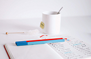 Image of notepad and pencils laid out on a table.